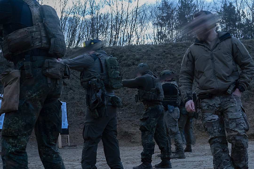 Military contractors in tactical gear during a training exercise